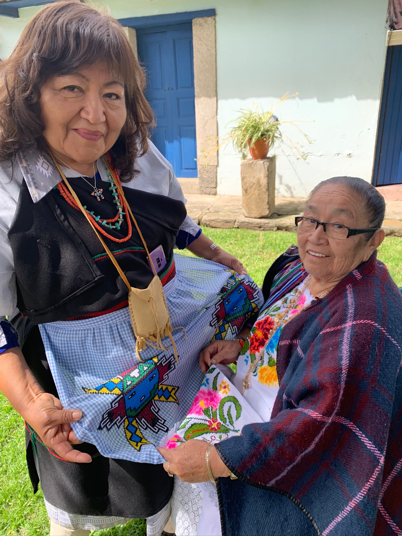  - Elder from Kawaika (Laguna Pueblo), New Mexico, U.S., left, compares traditional designs with a Yucatec Maya grandmother from Xul, Yucatan, Mexico, right. (Photo Credit: Isabel Hawkins, Yakanal)